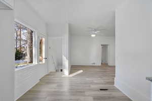 Interior space featuring ceiling fan, light hardwood / wood-style flooring, and a textured ceiling