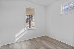 Unfurnished room with light wood-type flooring