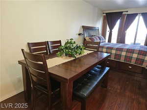 Dining space with dark hardwood / wood-style floors