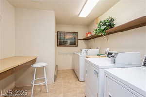 Washroom featuring a textured ceiling and washing machine and clothes dryer