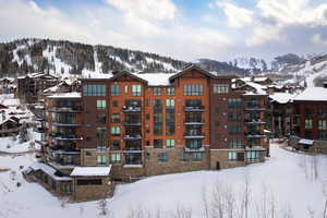 Snow covered property featuring a mountain view