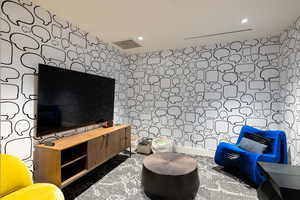 Sitting room featuring tile walls