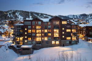 Snow covered property featuring a mountain view