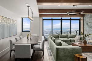 Dining room featuring wood-type flooring, beam ceiling, and a mountain view