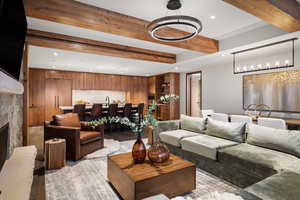 Living room with sink, a fireplace, and beam ceiling