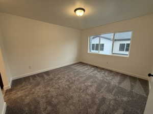 Spare room with dark carpet