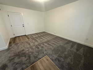 Empty room with dark colored carpet