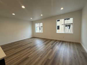 Empty room featuring dark hardwood / wood-style flooring