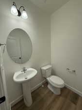 Bathroom featuring hardwood / wood-style floors and toilet