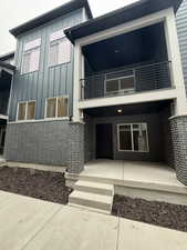 Rear view of property featuring a balcony