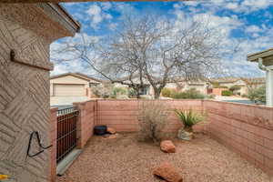 View of yard featuring a fenced backyard and a gate