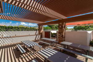 View of patio with fence and a pergola