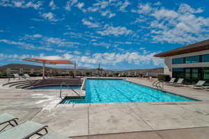 Community pool with a patio area and a mountain view