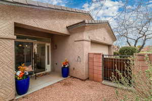 View of home's exterior with fence, an attached garage, and stucco siding