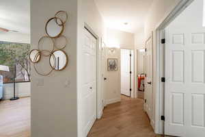 Hall with light wood finished floors and baseboards