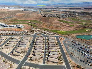 Birds eye view of property with a water and mountain view