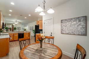 Dining room featuring visible vents, baseboards, a ceiling fan, light wood-style flooring, and recessed lighting