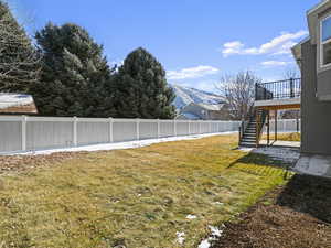 View of yard featuring a deck with mountain view