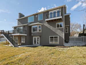 Back of house with french doors and a yard