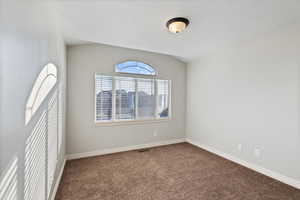 Carpeted bedroom with large window