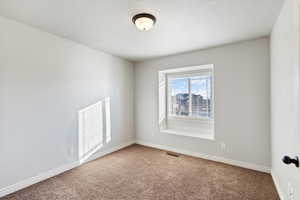 Carpeted bedroom with large window and a window seat