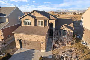 View of front of house with a garage and a mountain view