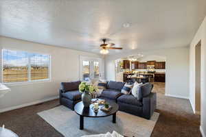 Living room featuring plenty of natural light, open to kitchen area