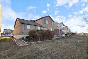 Rear view of house with a lawn