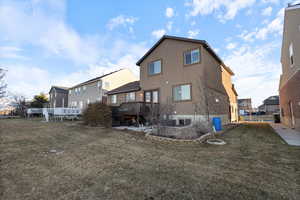 Rear view of property with a lawn