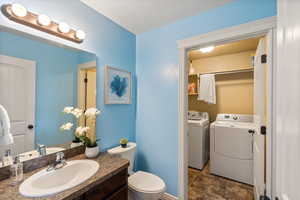 Half bathroom off of living room, leads to the laundry room