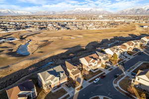 Birds eye view of property featuring a mountain view, stream & lake