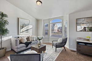 Front room with vaulted ceilings & large windows