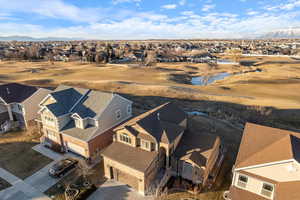 Bird's eye view of property on golf course  featuring a mountain view, stream & lake