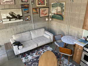 Living room featuring concrete flooring