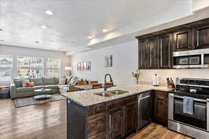 Kitchen with stainless steel appliances, kitchen peninsula, and sink