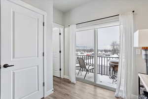 Hallway with light hardwood / wood-style flooring