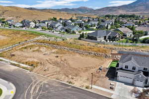 Aerial perspective of suburban area featuring a mountainous background