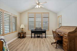 Office featuring vaulted ceiling, ceiling fan, and light wood-type flooring