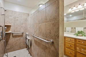 Bathroom with vanity and a tile shower