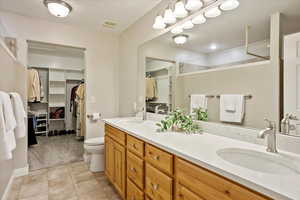 Bathroom with tile patterned flooring, vanity, and toilet