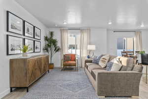 Living room featuring light hardwood / wood-style floors and a textured ceiling