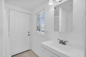 Bathroom featuring vanity and tile patterned floors