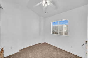 Unfurnished room featuring lofted ceiling, carpet floors, and ceiling fan