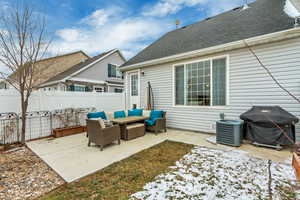 Patio with an outdoor living space, grilling area, and central AC unit