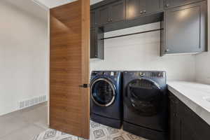 Laundry area with cabinets and washer and dryer