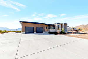 View of front of home with a garage and a mountain view