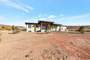 Rear view of property featuring a mountain view and covered porch