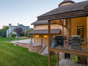 Back of property featuring a patio and a lawn