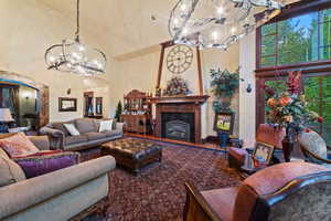 Living room featuring an inviting chandelier and a high ceiling