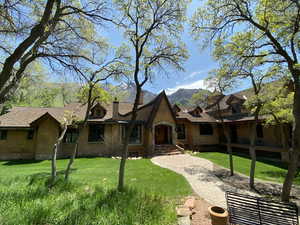 View of front facade with a mountain view and a front lawn